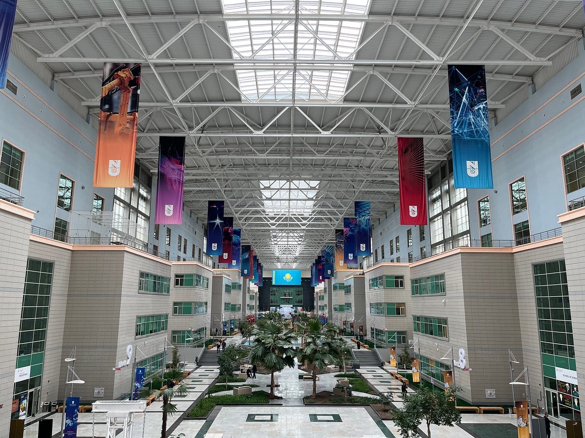 Pictures of Nazarbayev University. Note the corporate sponsorship and startup banners. The juxtaposition of banners celebrating corporate sponsorships and third party rankings with the astroturf sitting areas struck me as apt.